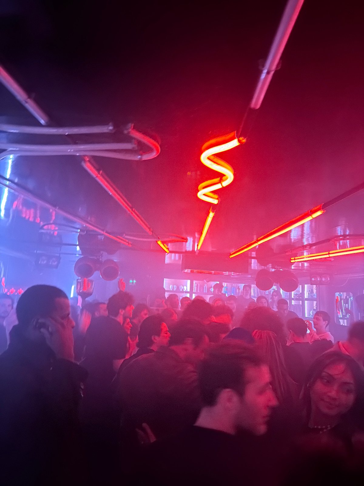 Early morning crowd gathered in dimly lit Paris interior