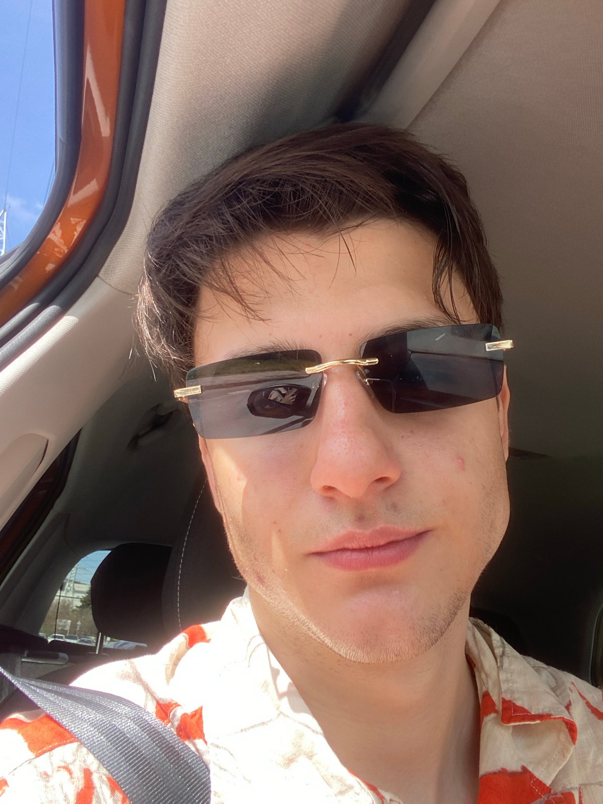 Man in sunglasses photographed in car driver's seat, Varna
