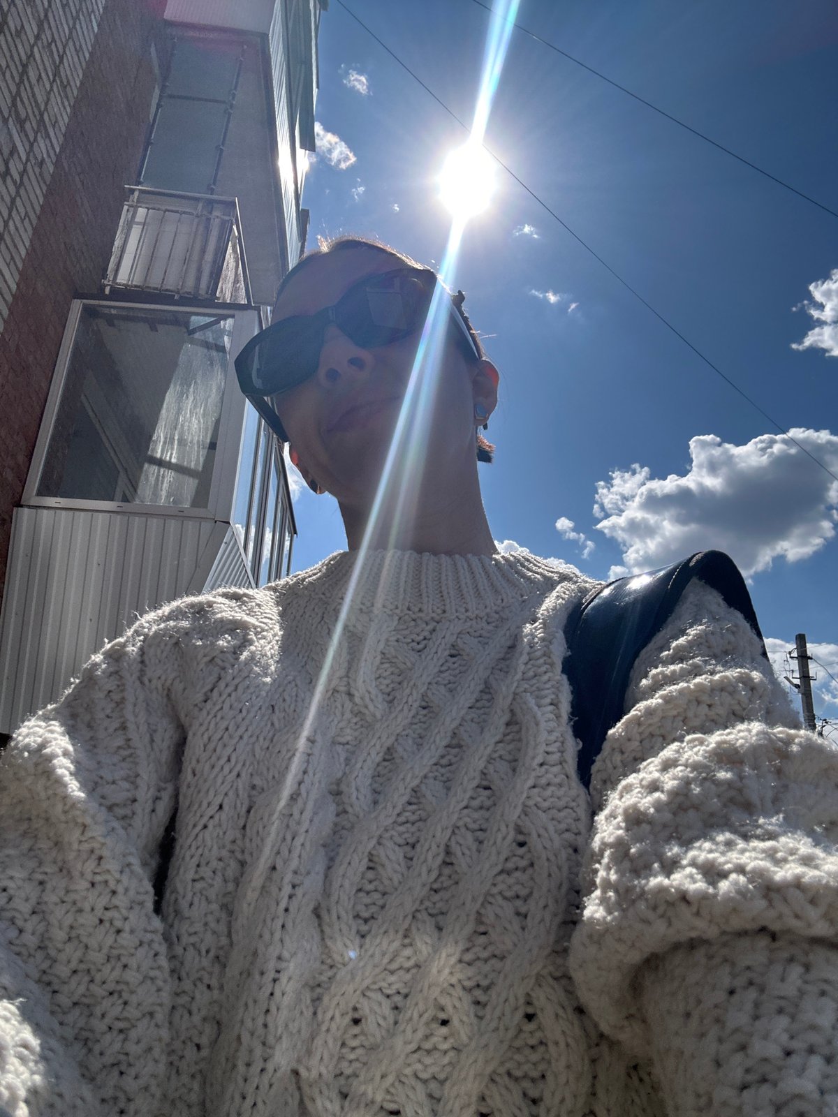Person takes outdoor selfies in cream sweater in Votkinsk
