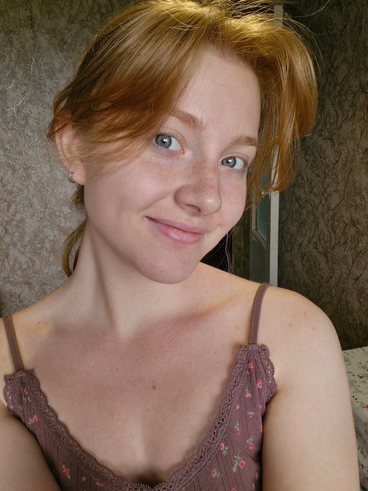 Woman in brown floral top photographed in morning portrait session