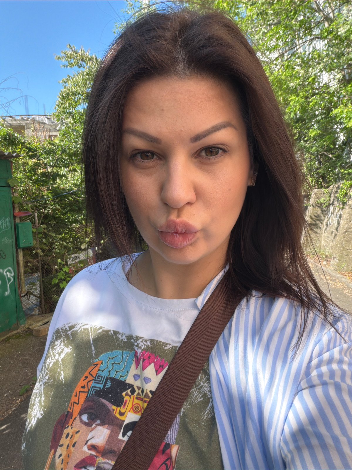 Woman takes morning selfies in residential Sochi neighborhood