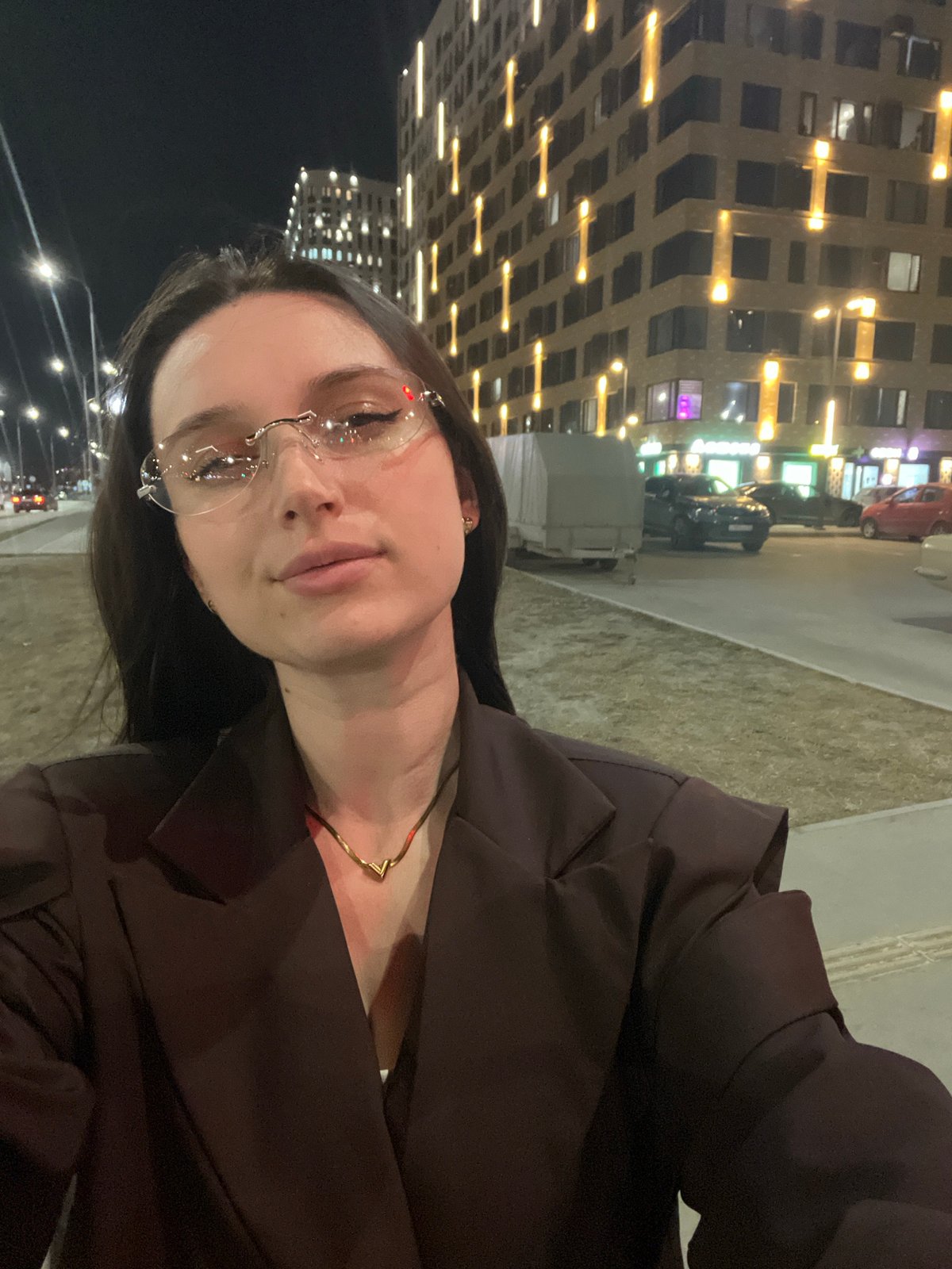 Woman documents evening street walk with selfies in Tyumen