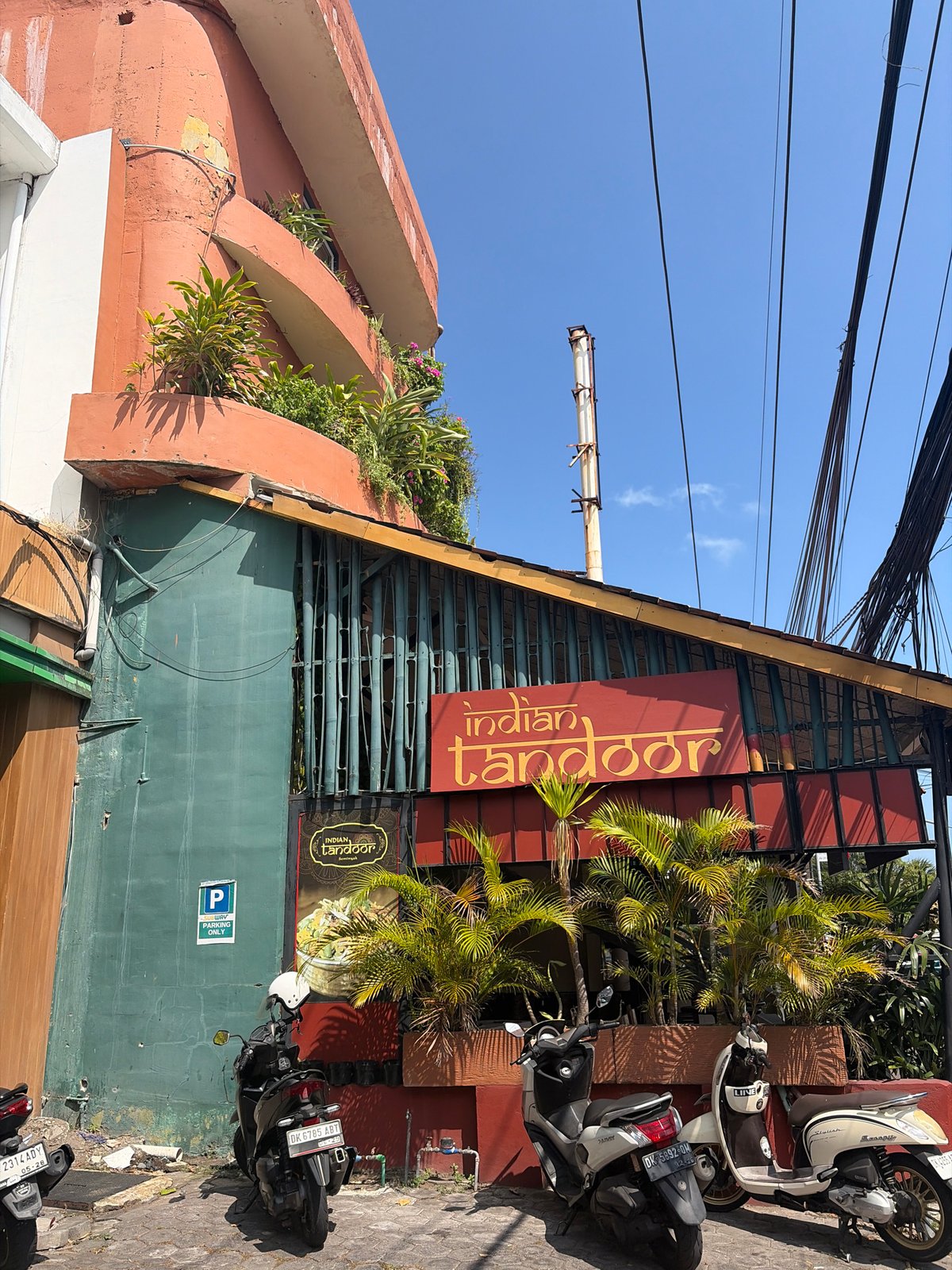 Kuta street scene: shops, scooters, and Balinese street detail