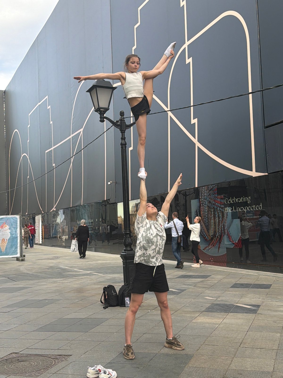 Street acrobats perform balancing stunt on Moscow lamppost