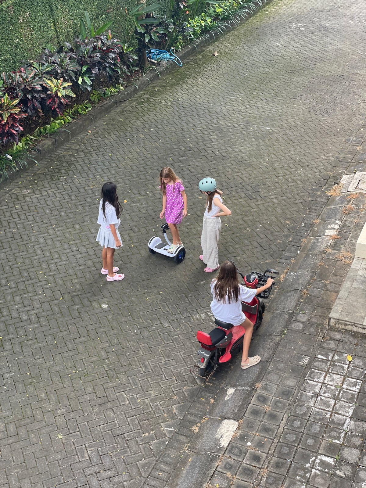 Early morning scenes of children playing, street traffic in Kuta Selatan