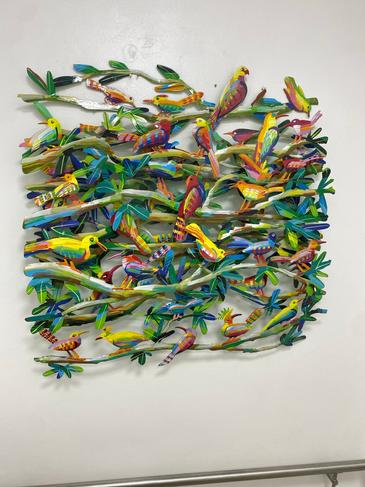 Colorful bird and tree wall sculpture spotted