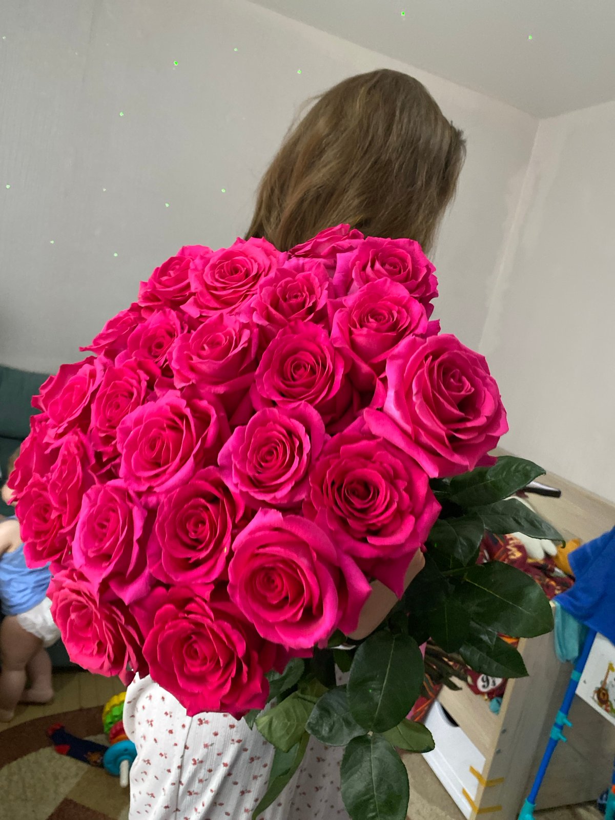 Woman receives pink roses during home cooking in Votkinsk
