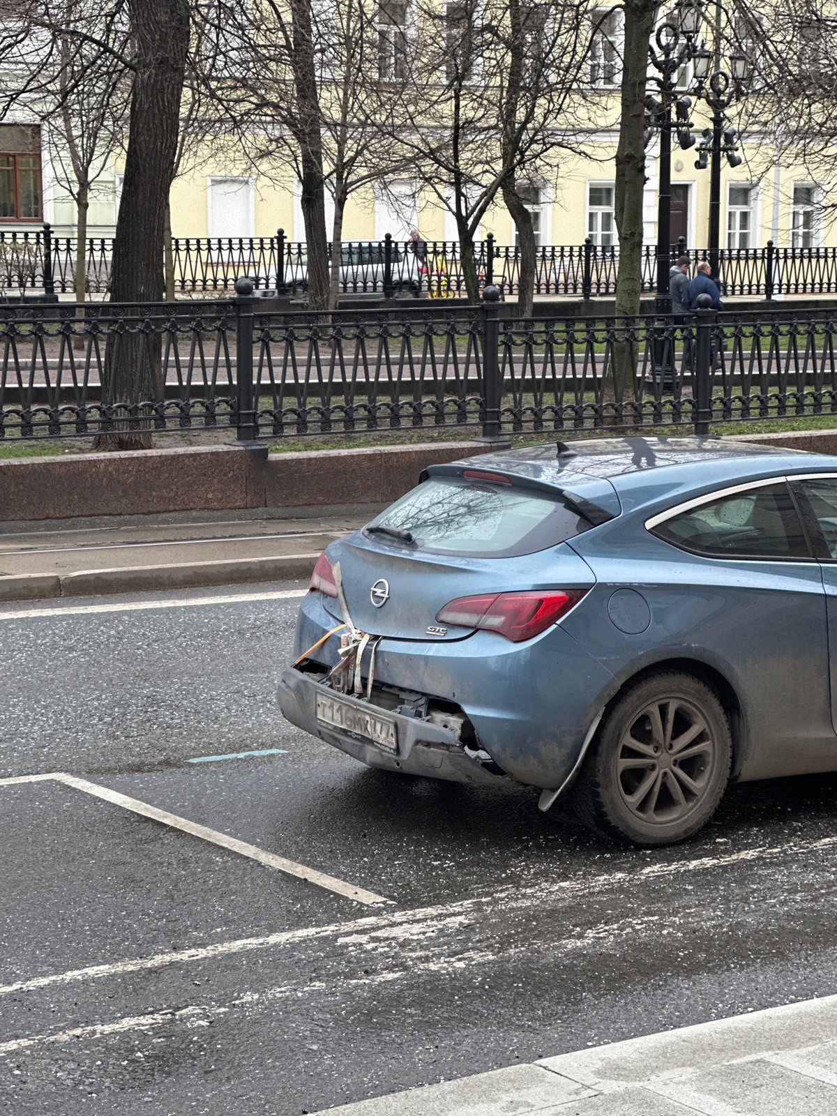 Damaged Opel Astra observed on Moscow street amid wet conditions