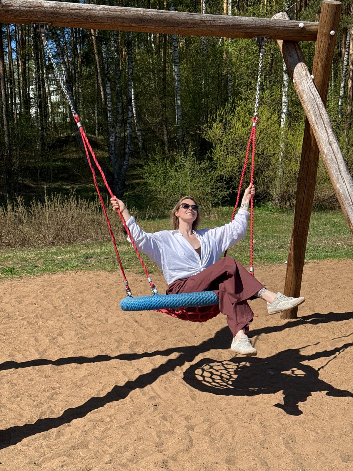 Woman enjoys tire swing at Chaikovsky recreation area