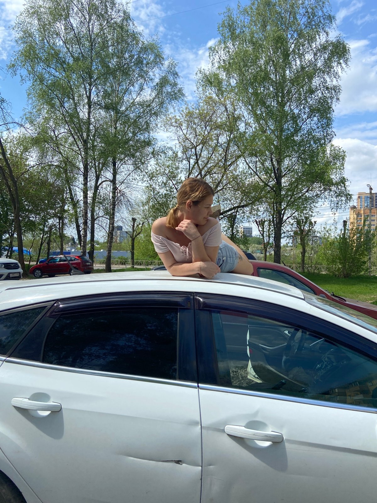 Woman enjoys sunny morning walk with dog in Ryazan