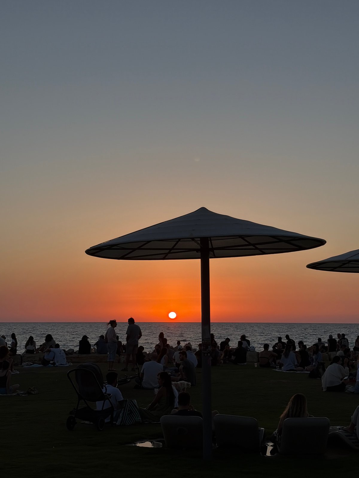 Sunset gathering draws crowds to Tel Aviv coastline
