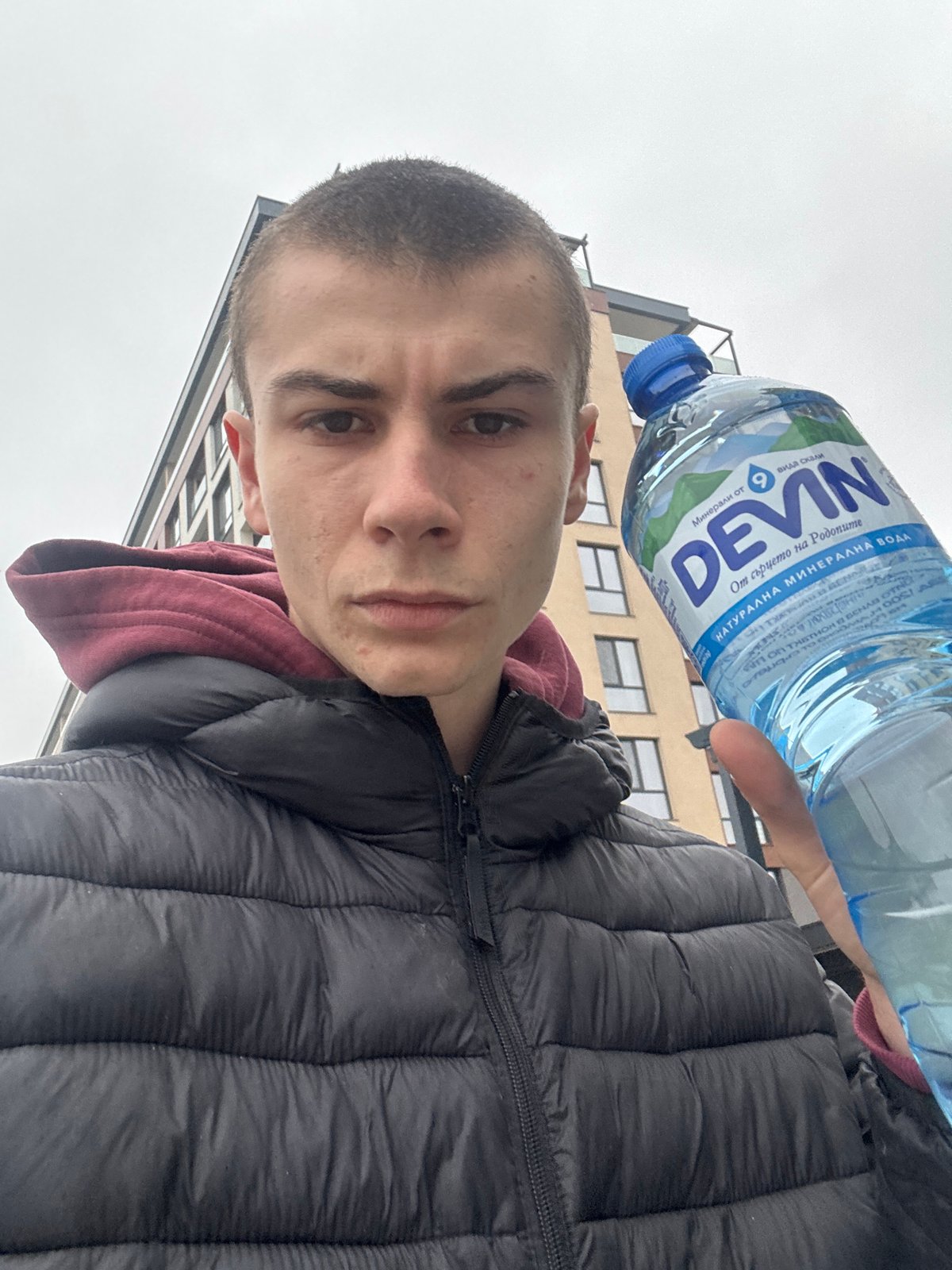 Person with water bottle documented around Plovdiv building