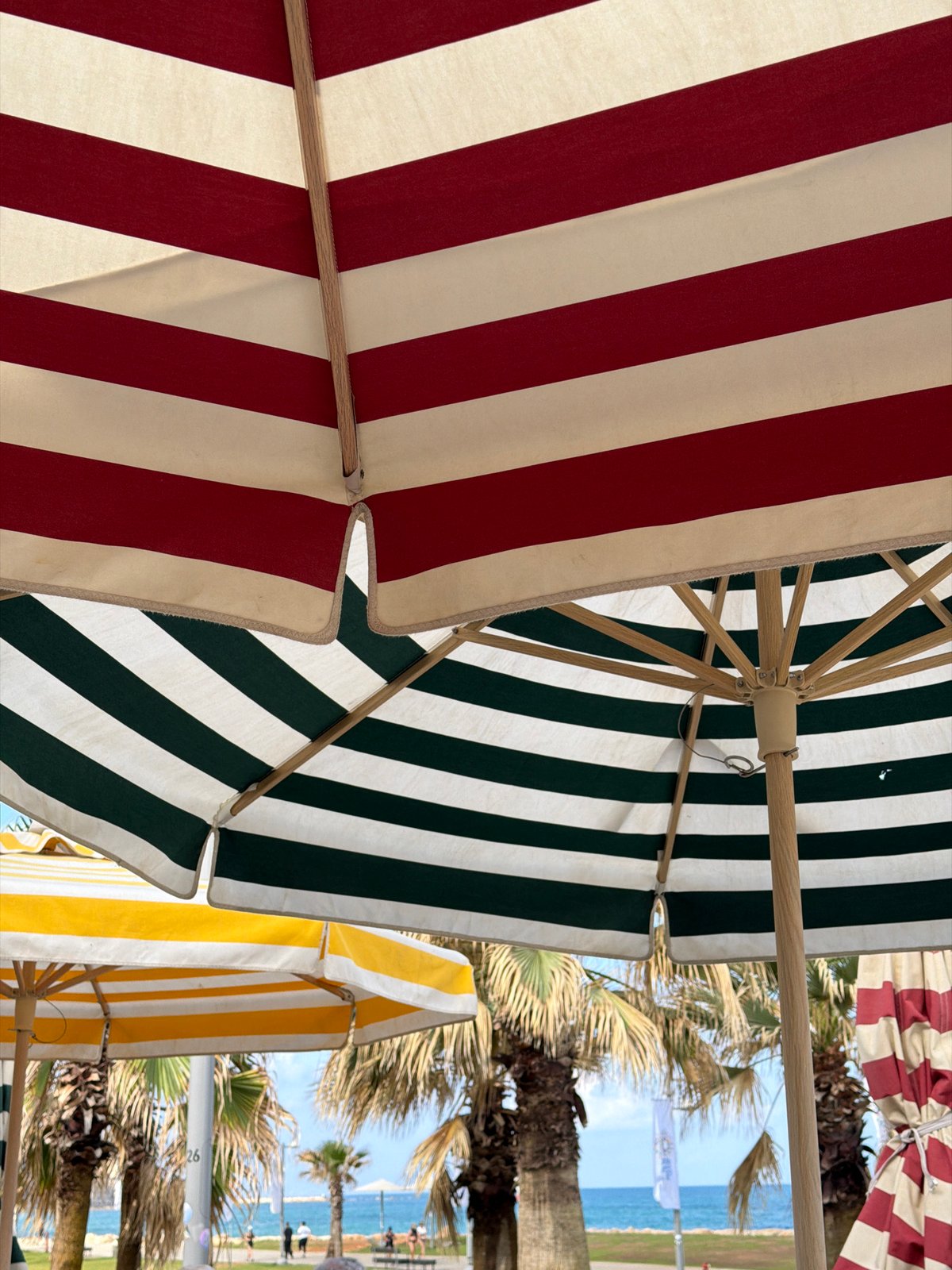 Lazy morning under striped umbrellas on a Tel Aviv beach