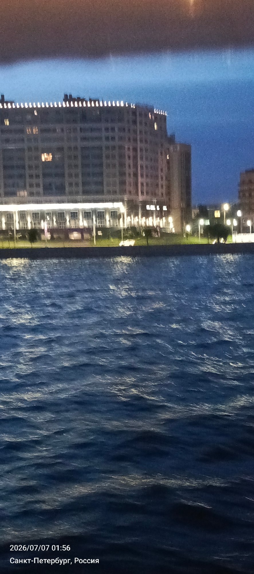 Saint Petersburg waterfront at night, domes and modern buildings