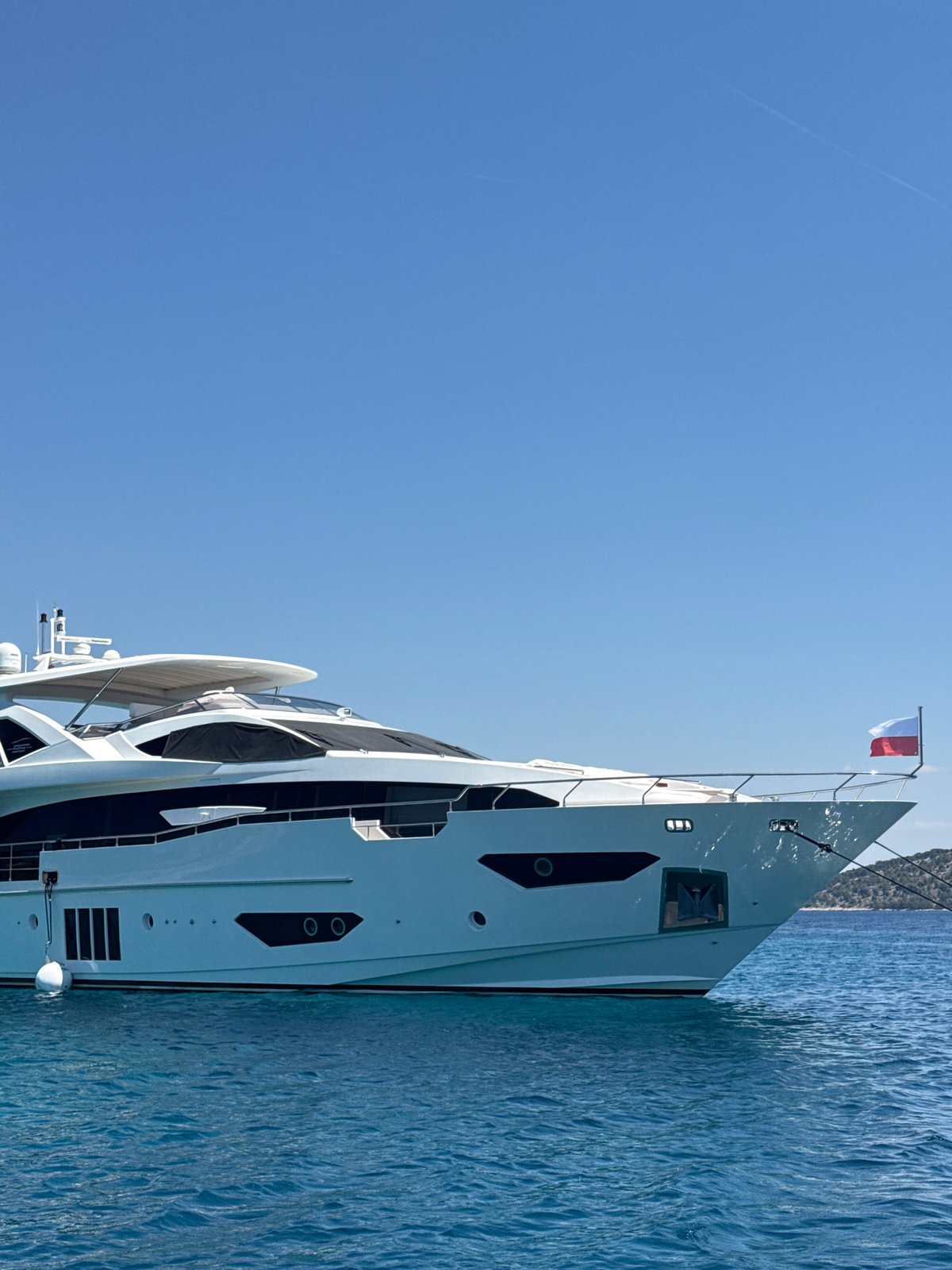 Luxury yacht anchored off Šibenik with waterside dining nearby