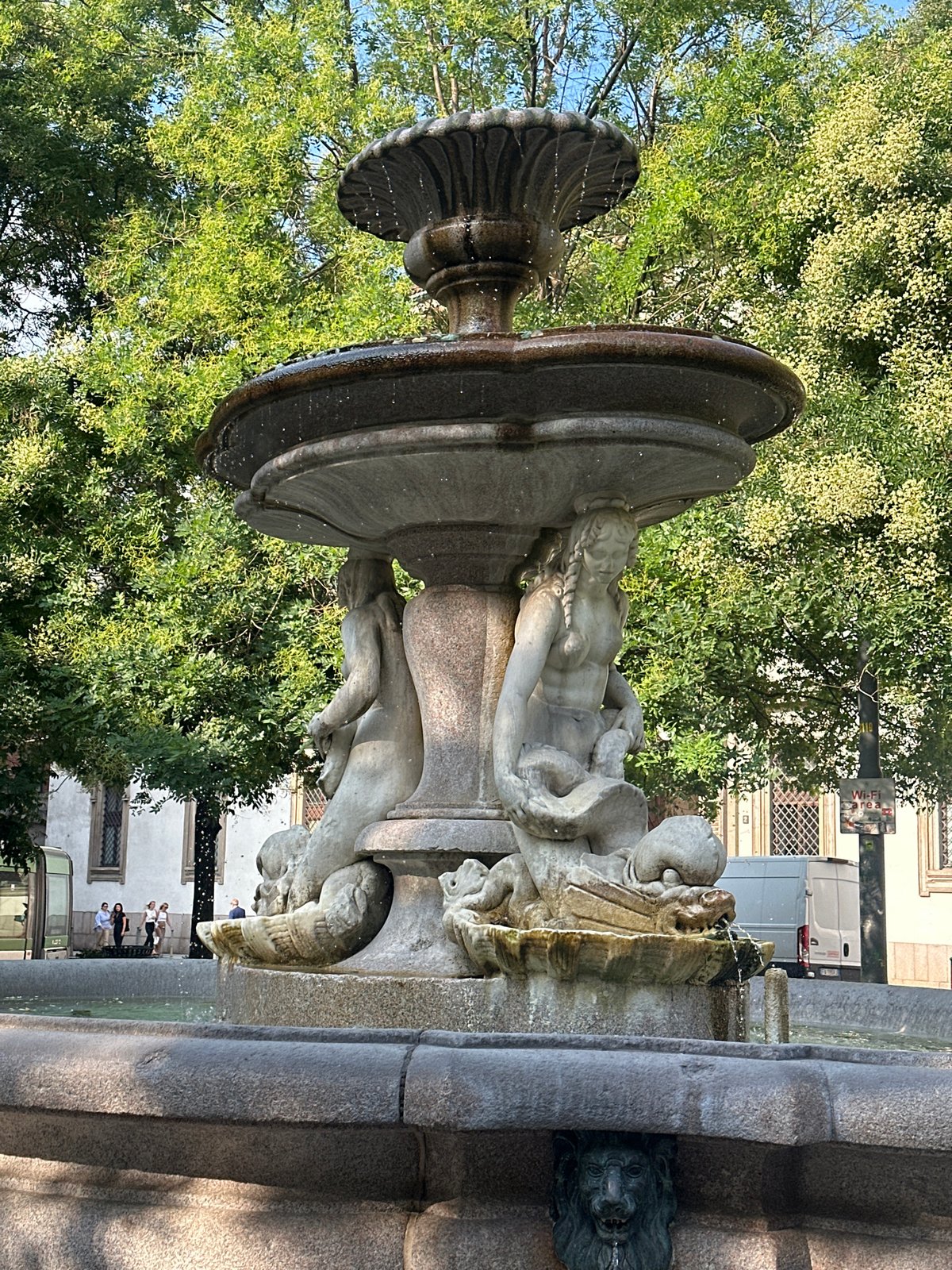 Ornate stone fountain with marine sculptures in Milan