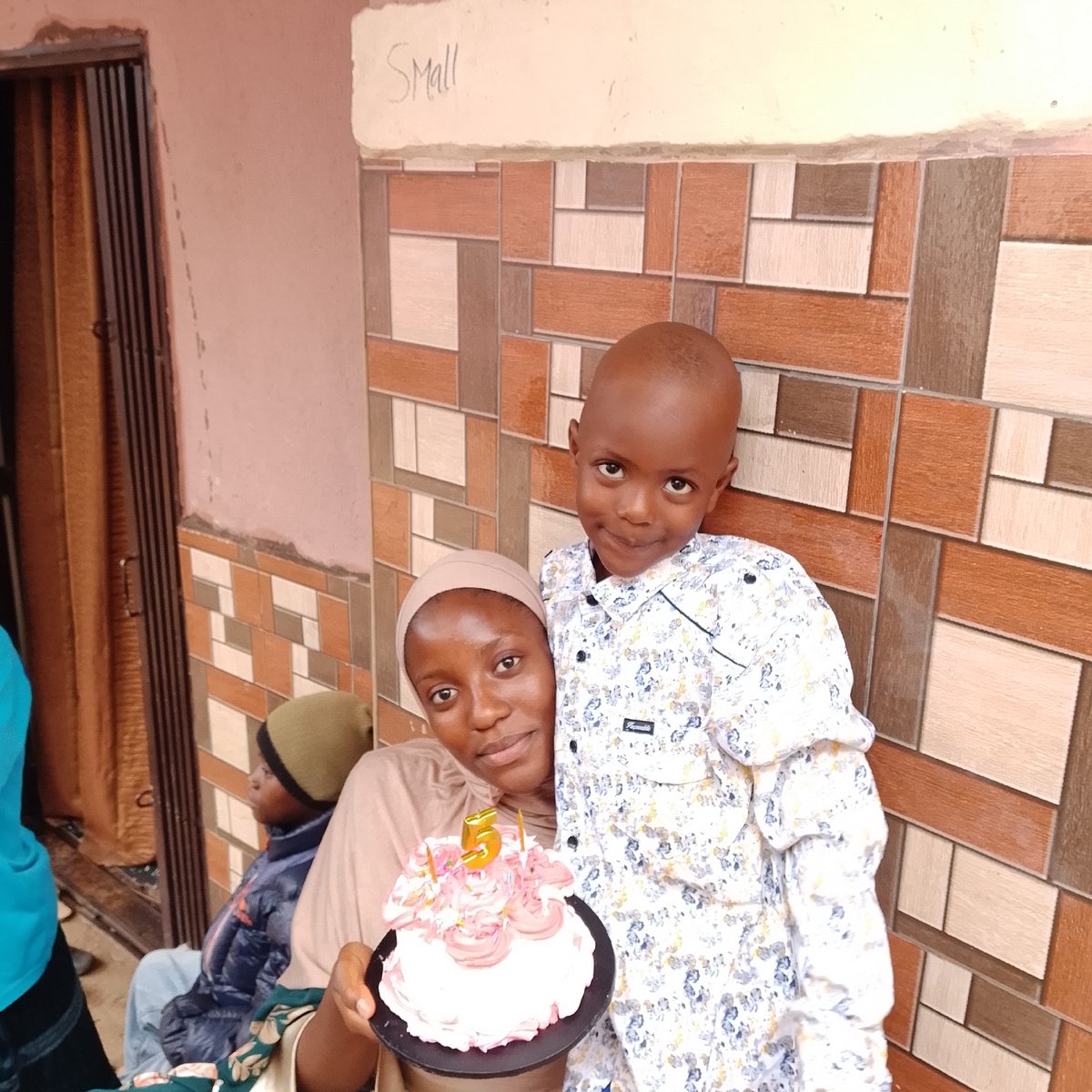 Birthday cake and street life in a busy West African neighborhood