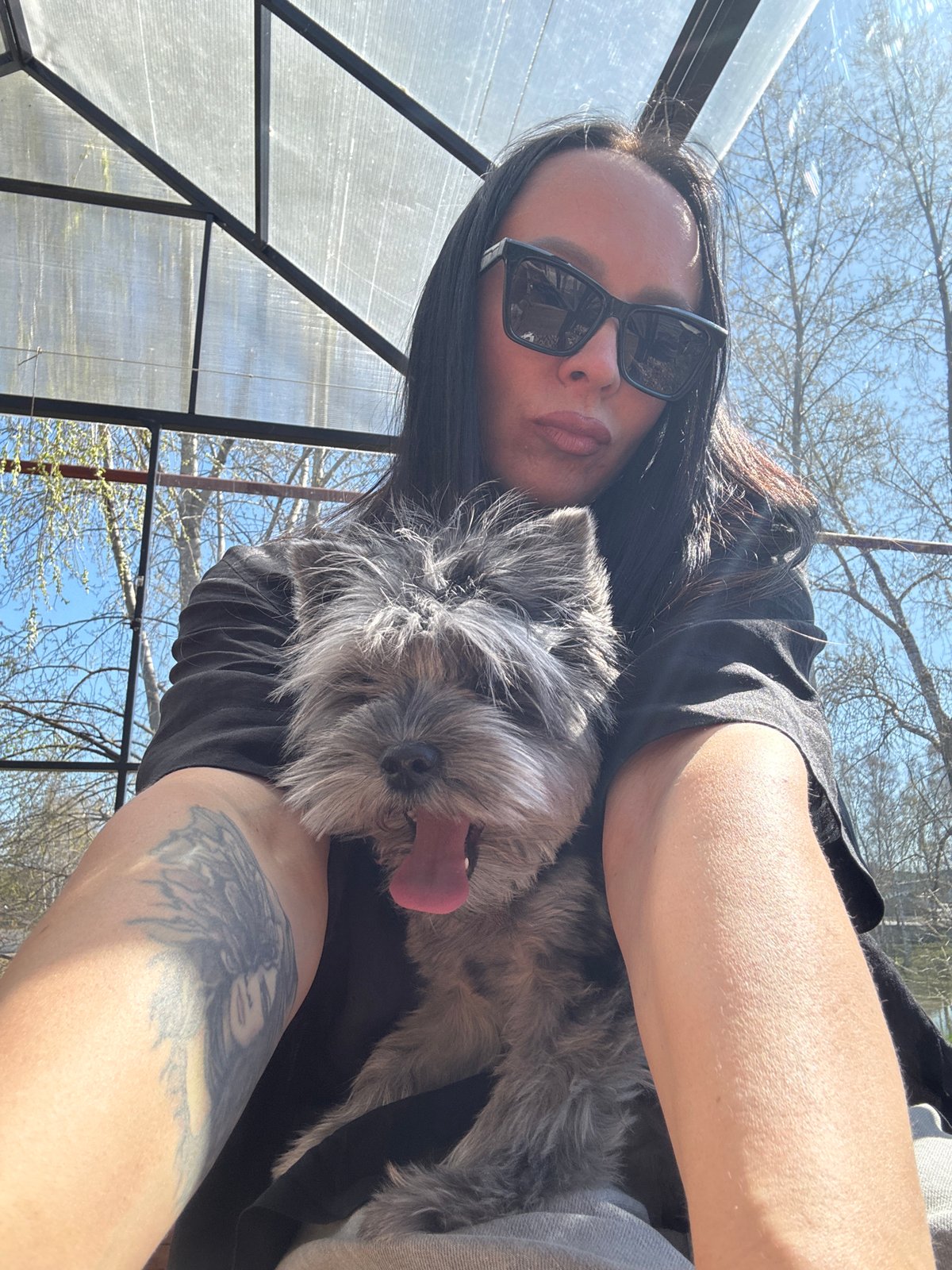 Woman enjoys morning park visit with dog in Chaikovsky