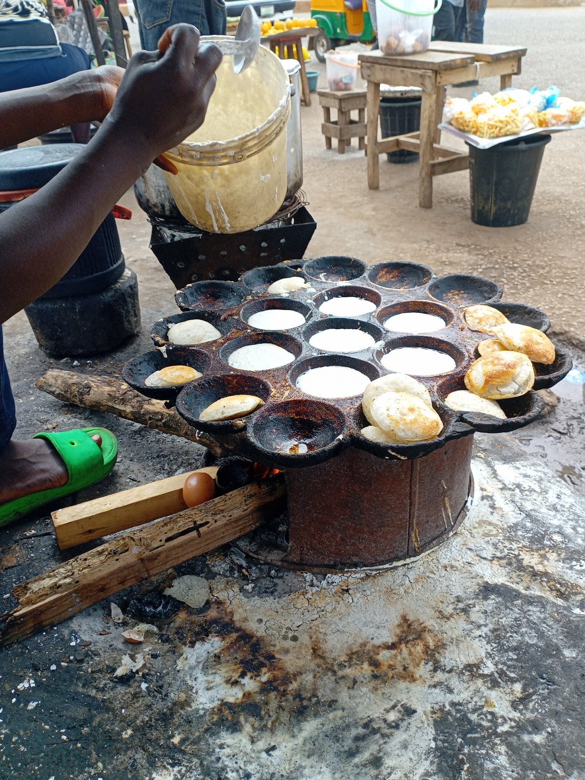 Street vendors prepare traditional puff-puff snacks in Bukuru Nigeria