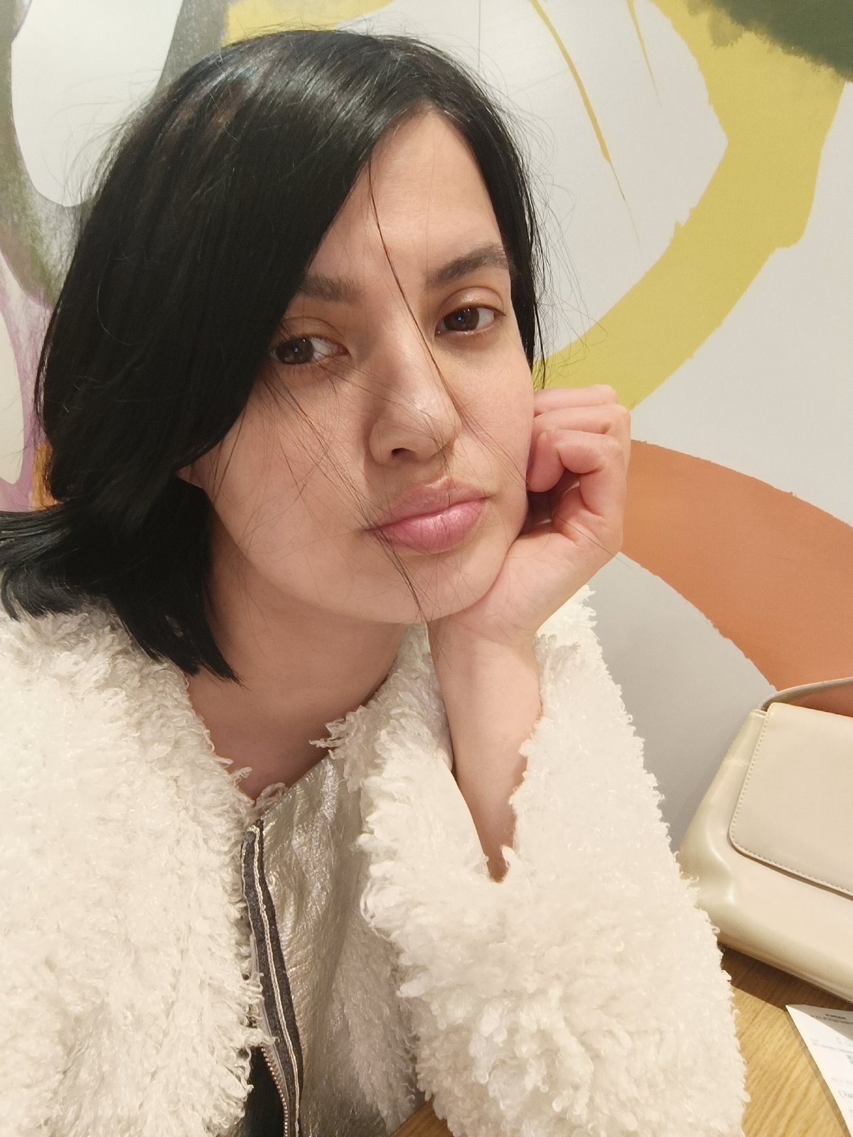 Woman in white jacket observed in contemplative pose