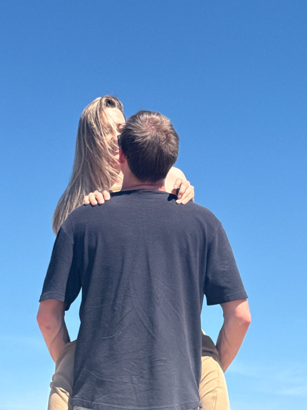Couple poses for photos on beach in Chaikovsky, Russia
