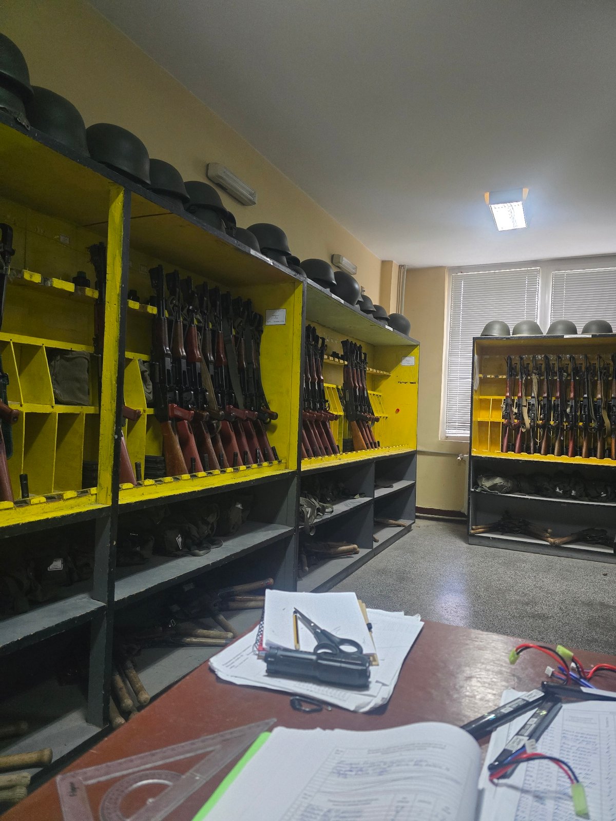 Witness documents organized weapon storage facility with rifles, helmets