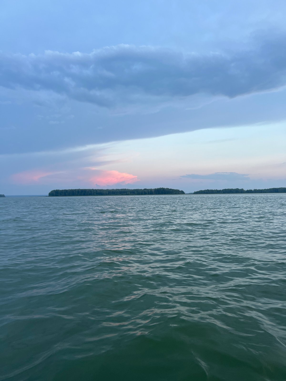 Still water and pastel skies near Novopichugovo at golden hour