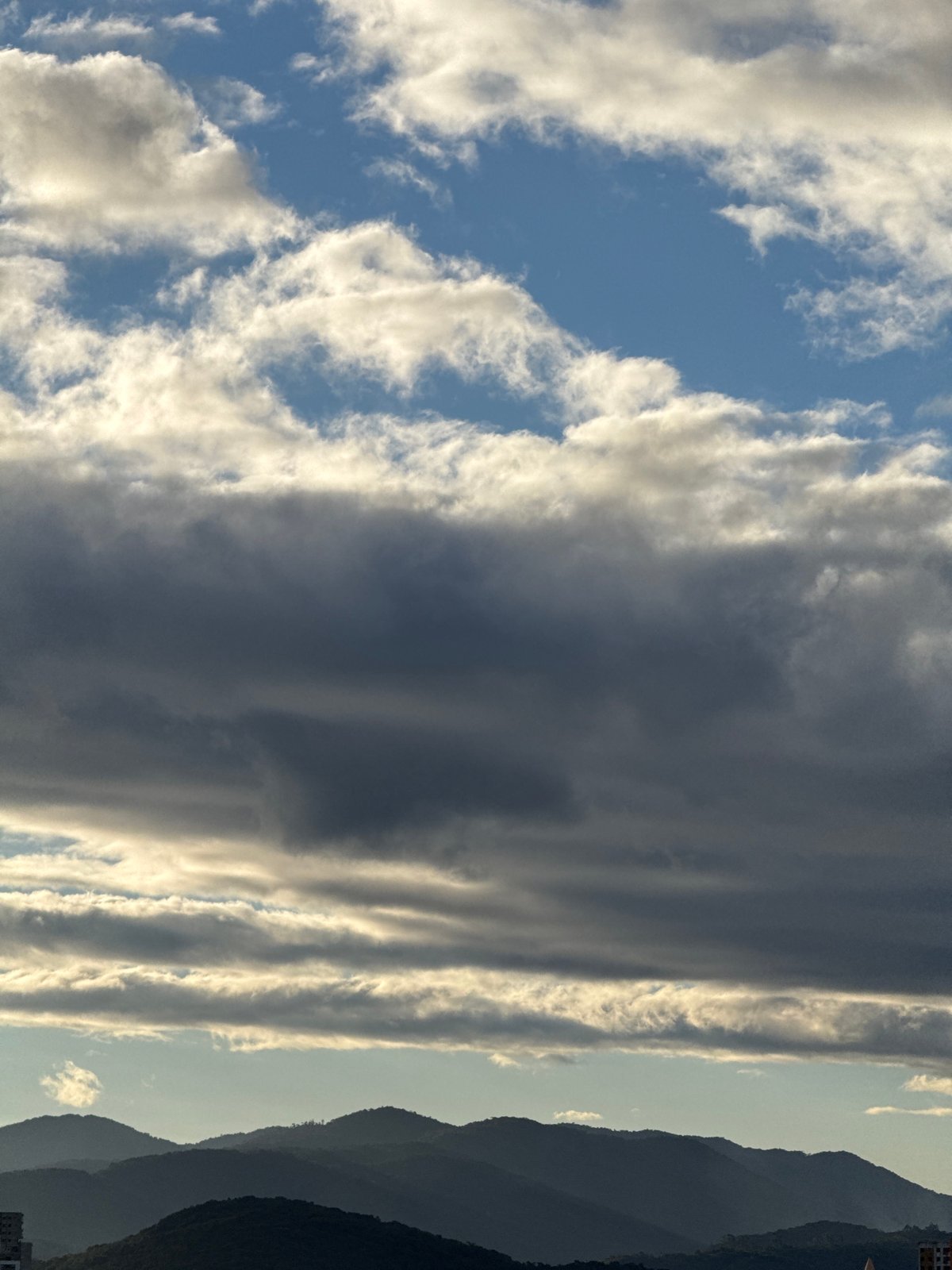 Dramatic cloud formations above mountainous terrain