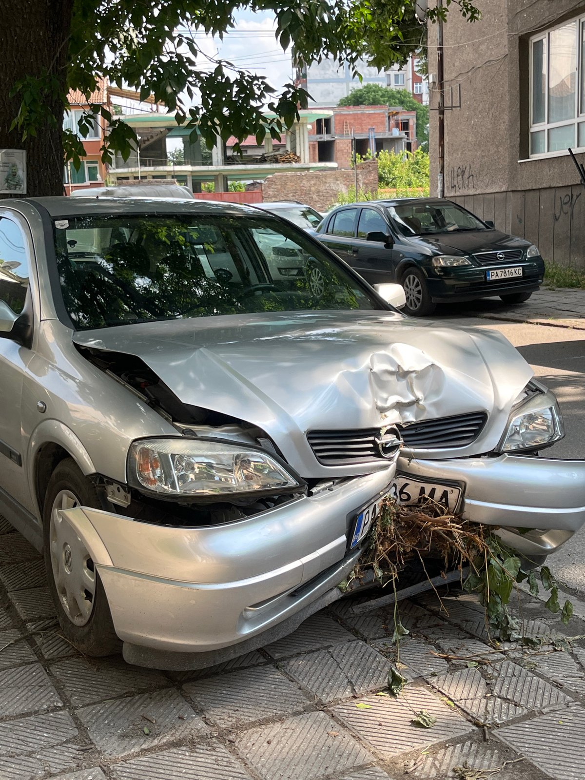 Damaged vehicle documented on Pazardzhik street amid residential buildings
