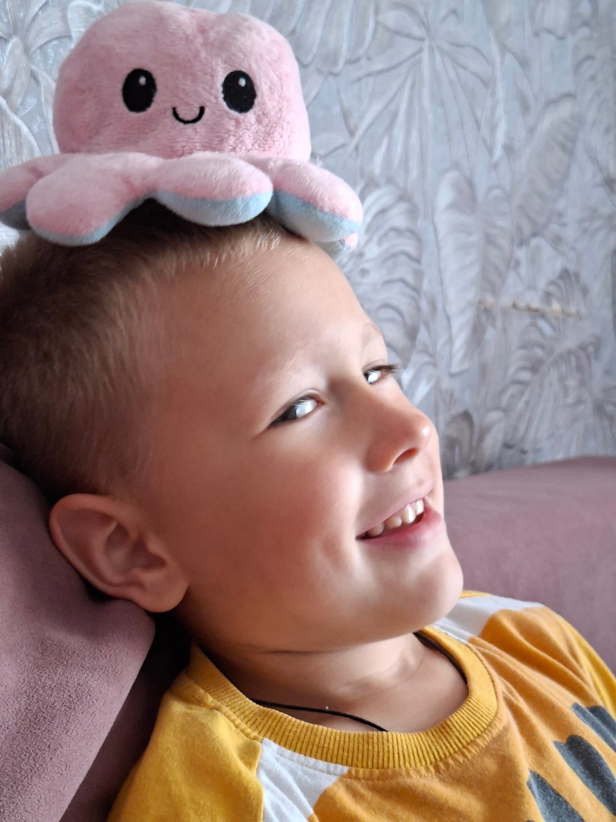 Kids playing indoors with a stuffed octopus and Lion King gear