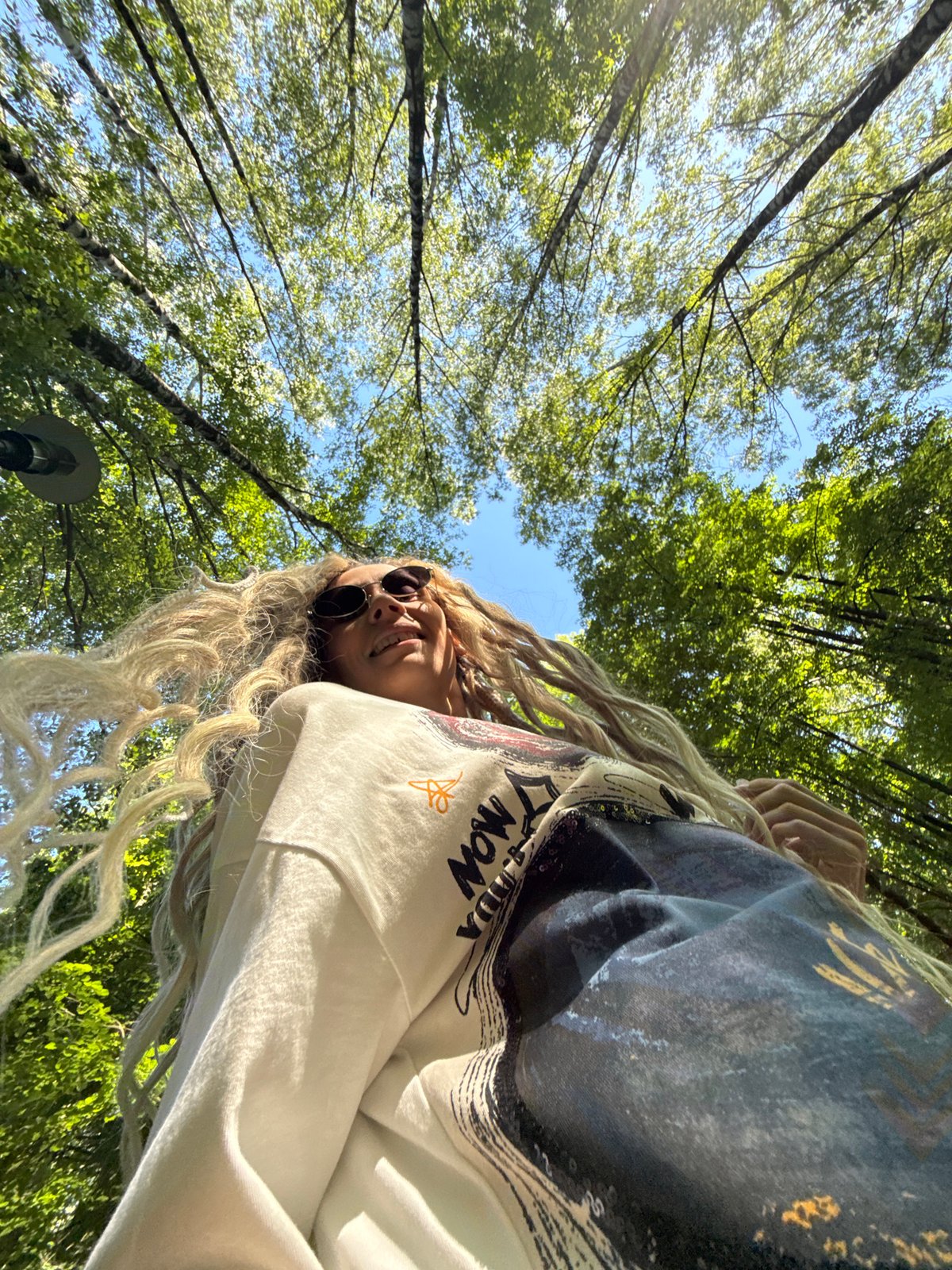 Woman takes forest selfies in Rusanovo during morning photo session
