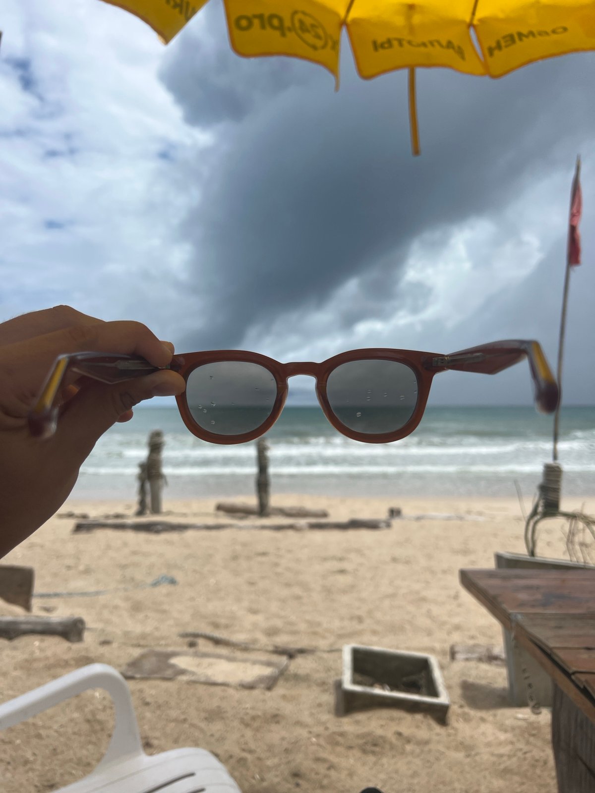 Stormy beach day with vendors, swimmers, and laptop workers