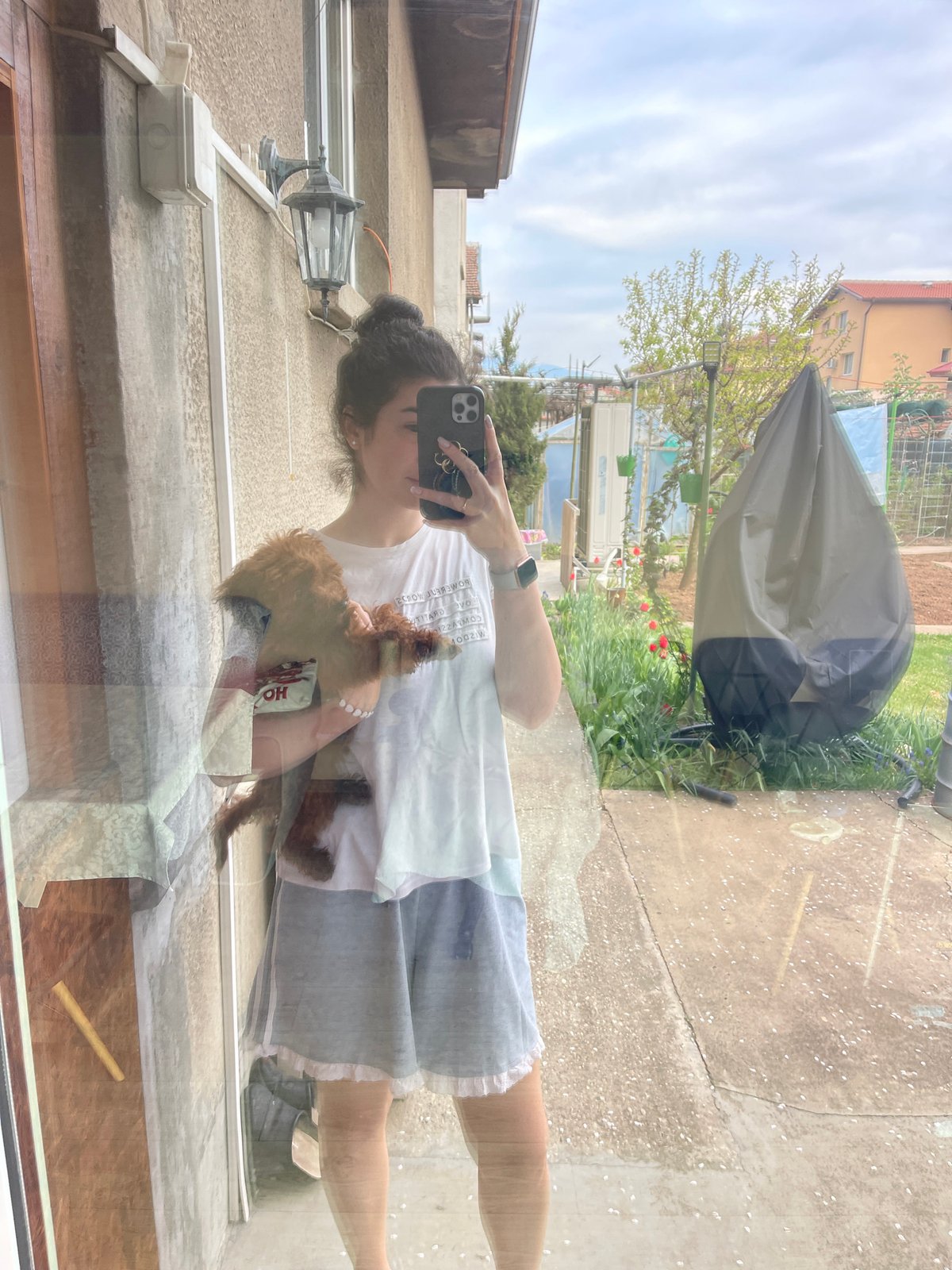 Woman spends quiet morning with poodle in Sofia bedroom