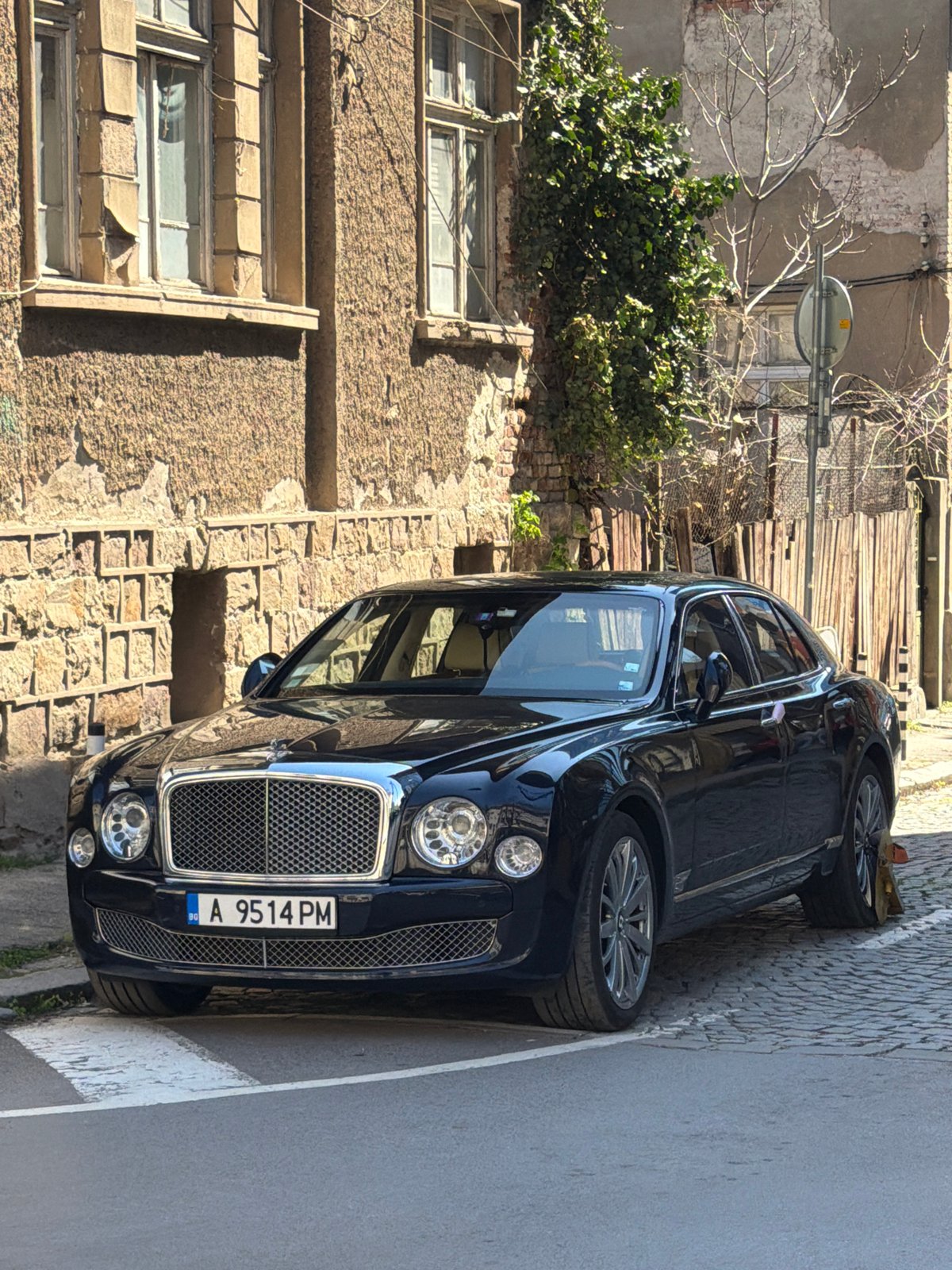 Bentley with Bulgarian plates parked on Sofia cobblestone street