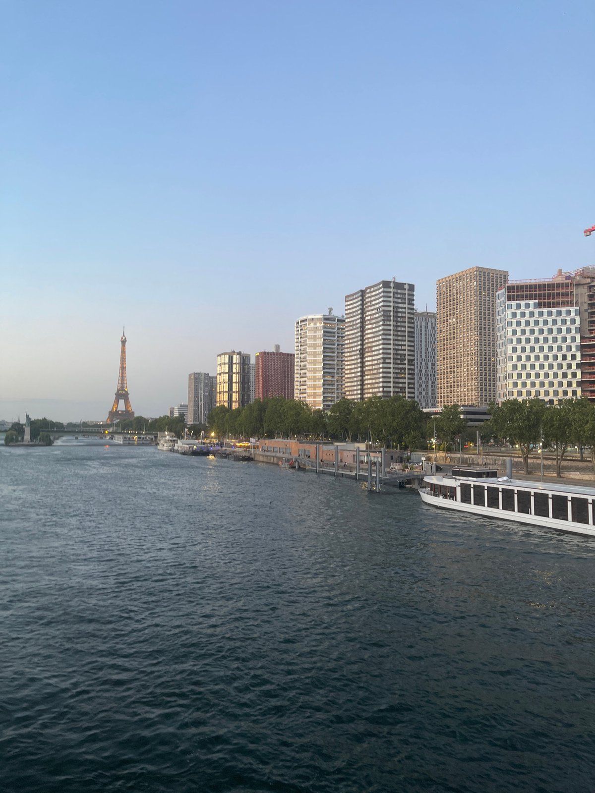 Eiffel Tower glowing at dusk along the Seine