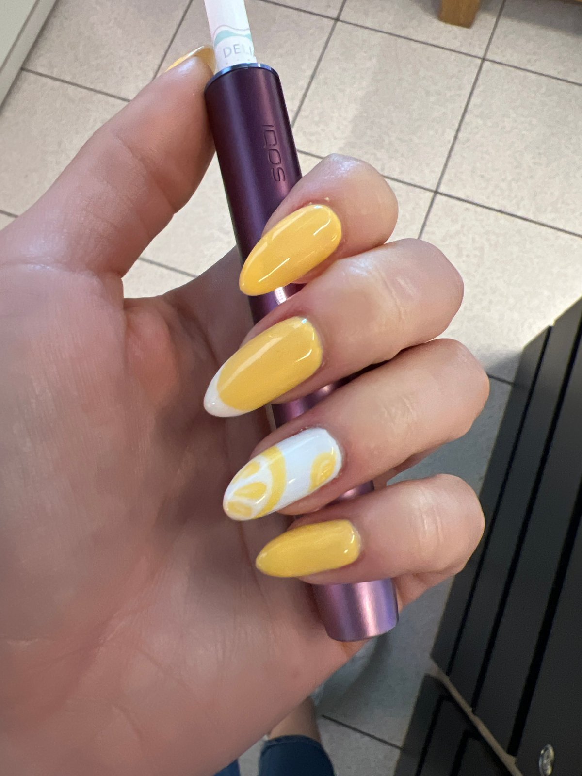 Yellow nails and a metallic purple IQOS in Pazardzhik