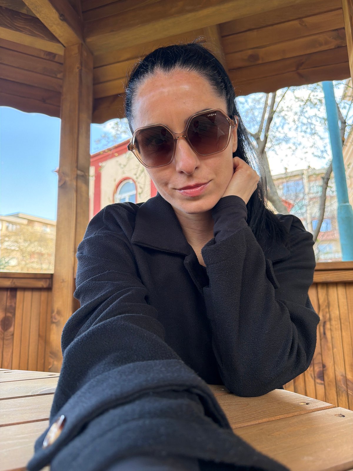 Woman in sunglasses rests at park structures in Pleven