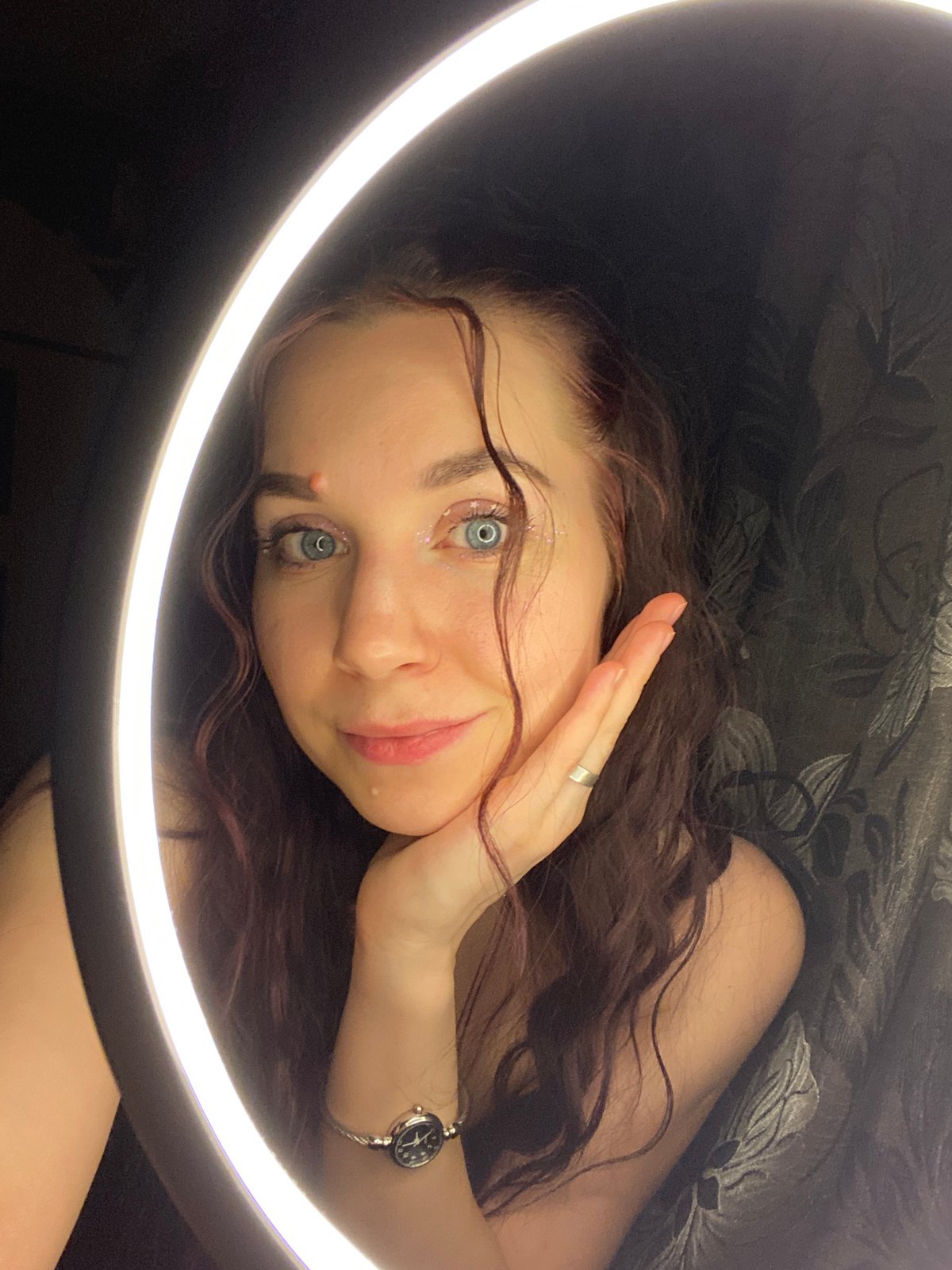 Woman poses for ring light photo session in Chaikovsky