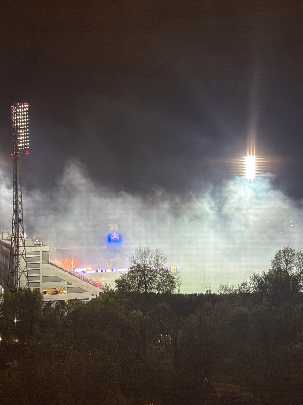 Smoke fills crowded stadium during nighttime sporting event