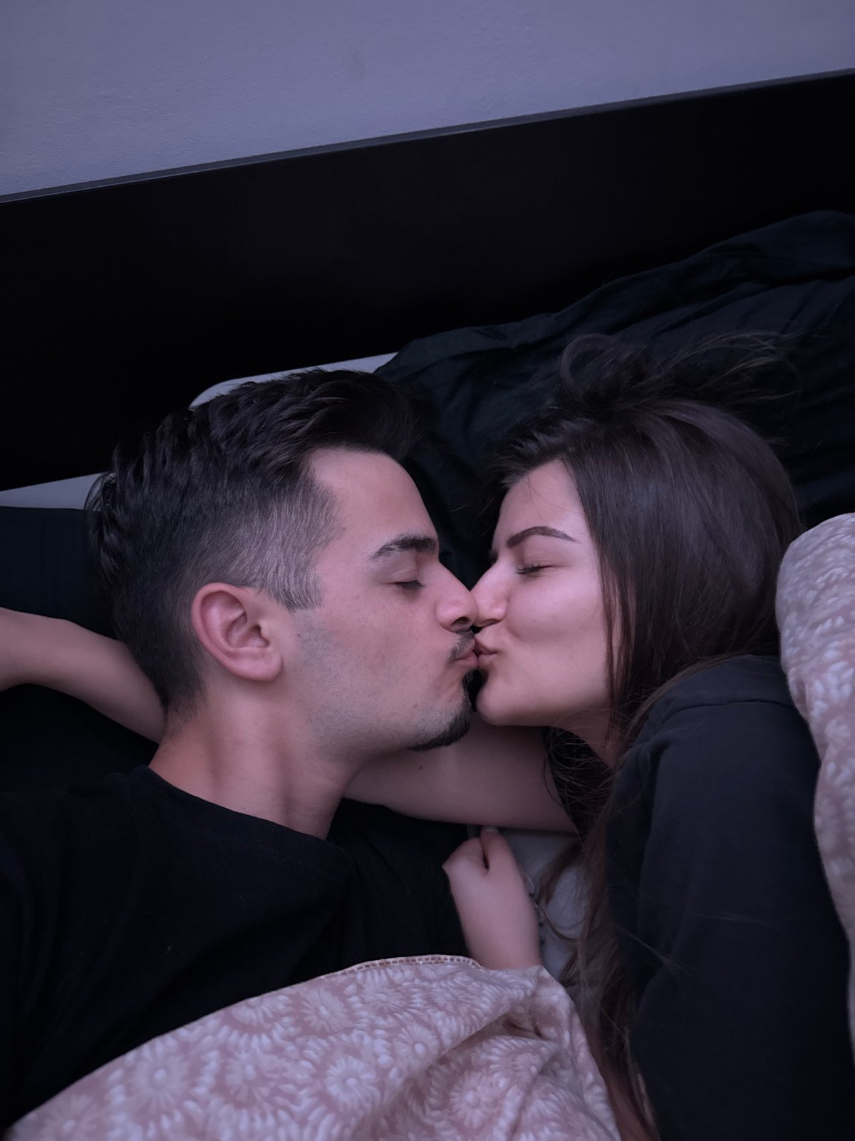 Intimate moment captured between couple in Sofia bedroom