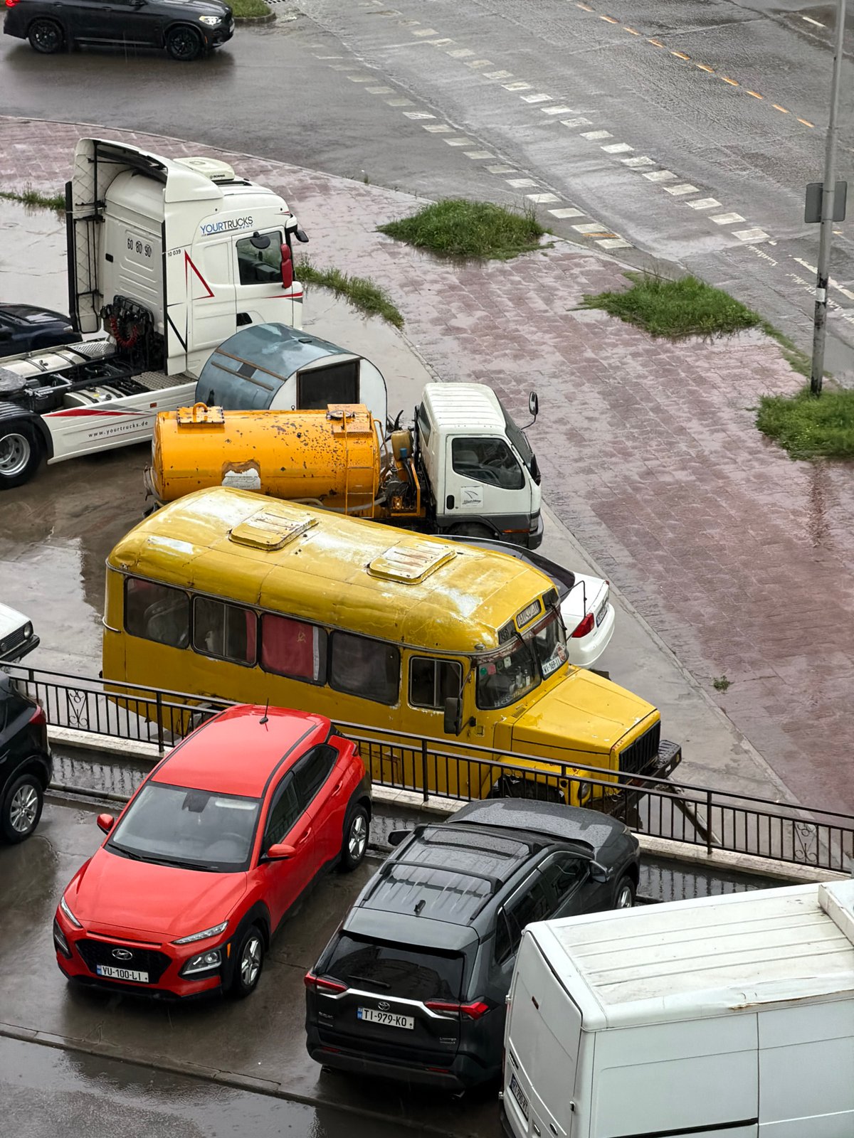 Woman takes indoor selfies during rainy afternoon in Tbilisi