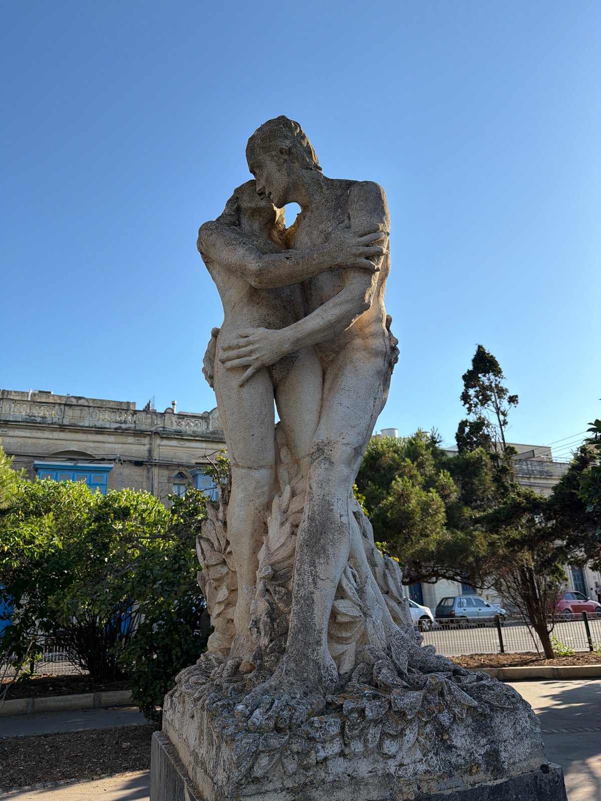 Expressive stone sculpture of two entwined figures in Rabat, Malta