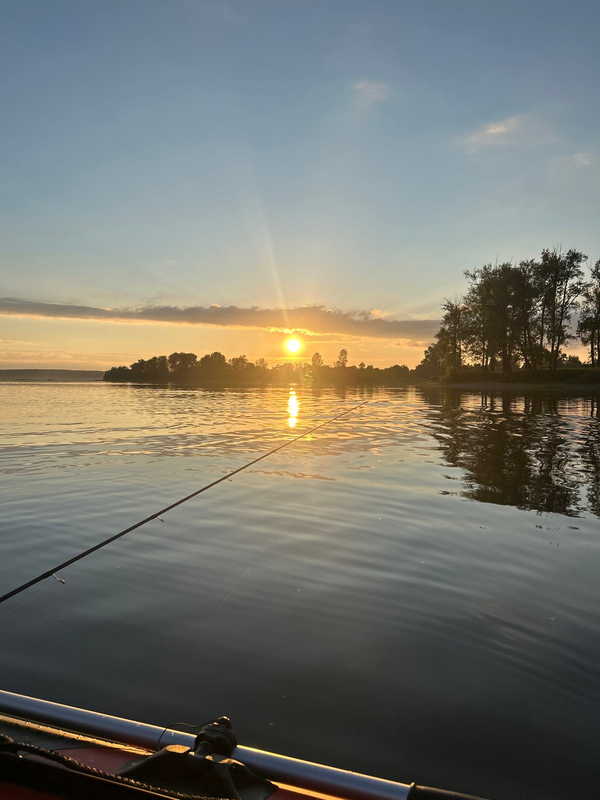 Catfish caught from inflatable boat at sunset, Ol'khovskoye