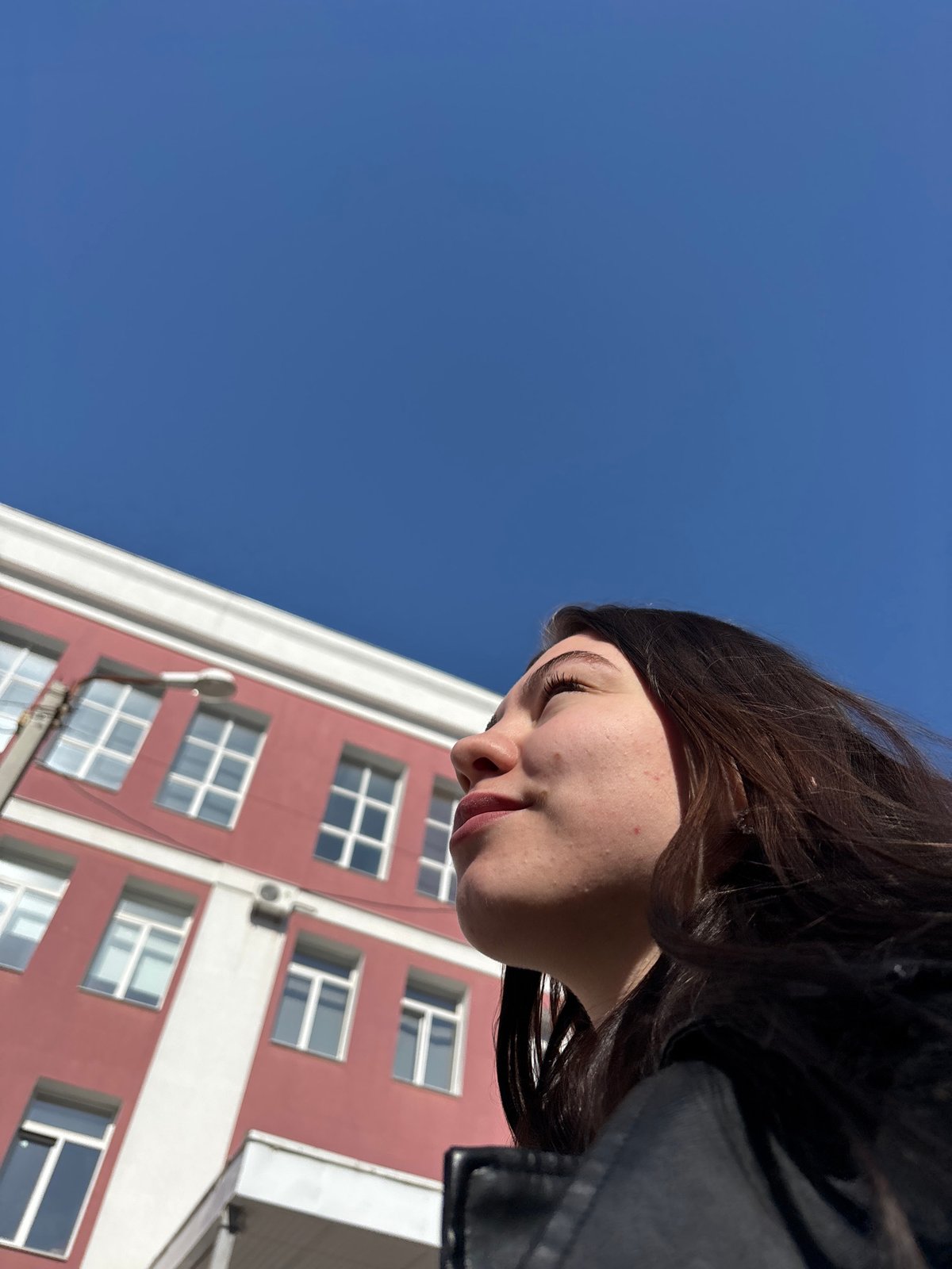 Woman photographed against building backdrop in Perm, Russia