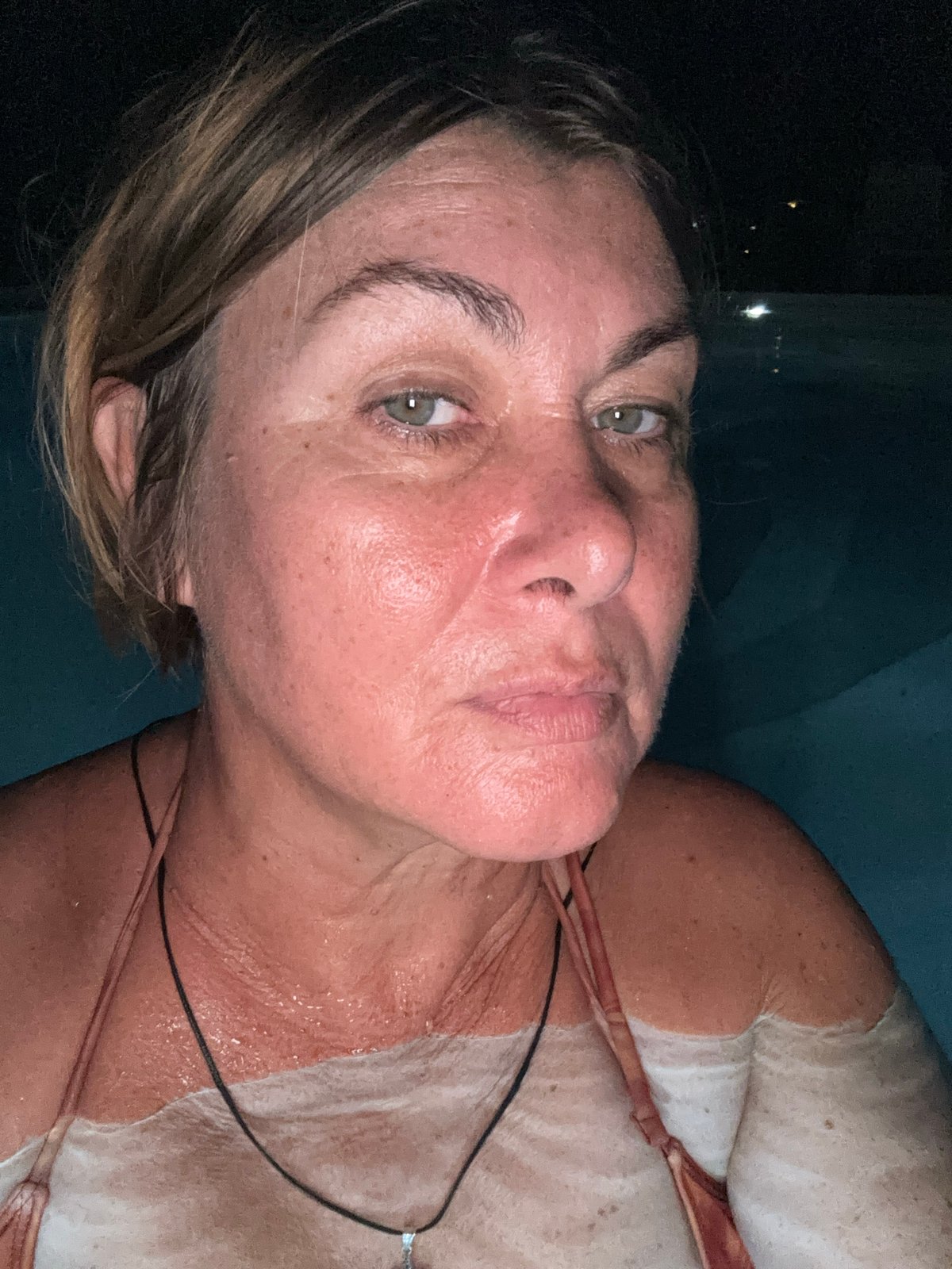 Woman swimming at night in Ban Bang Rak pool