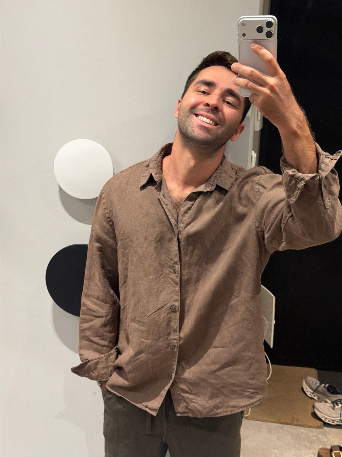 Selfie against a minimalist grey wall with circular decor