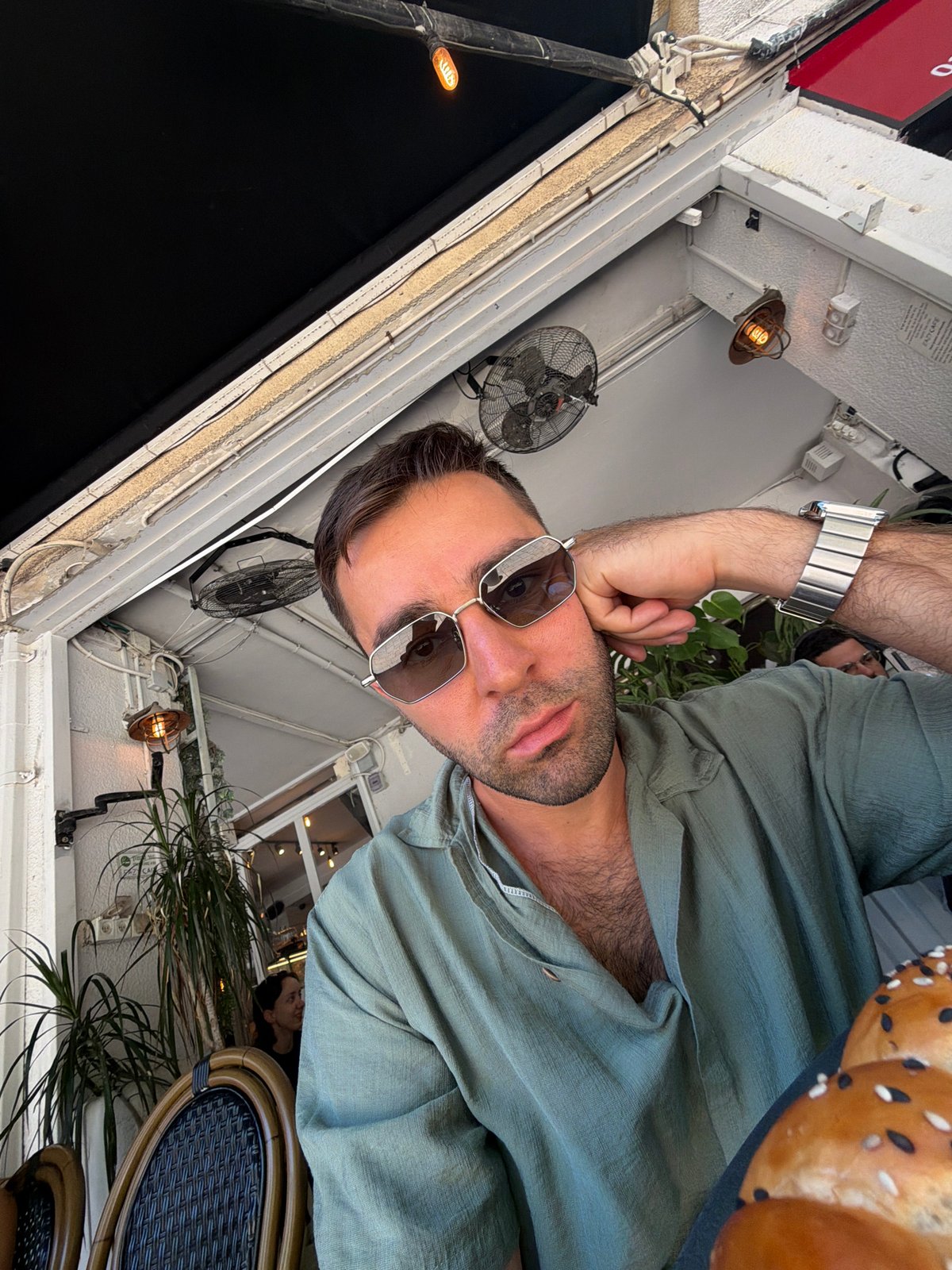 Casual Tel Aviv morning: café, street posters, and sidewalk scenes