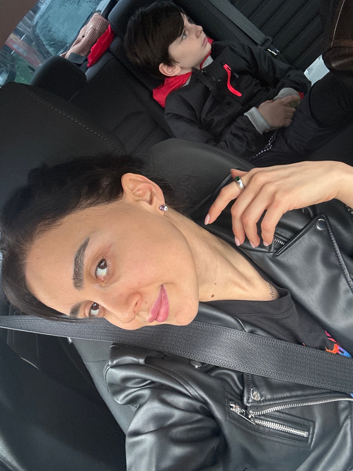 Woman and child travel by car in Tbilisi