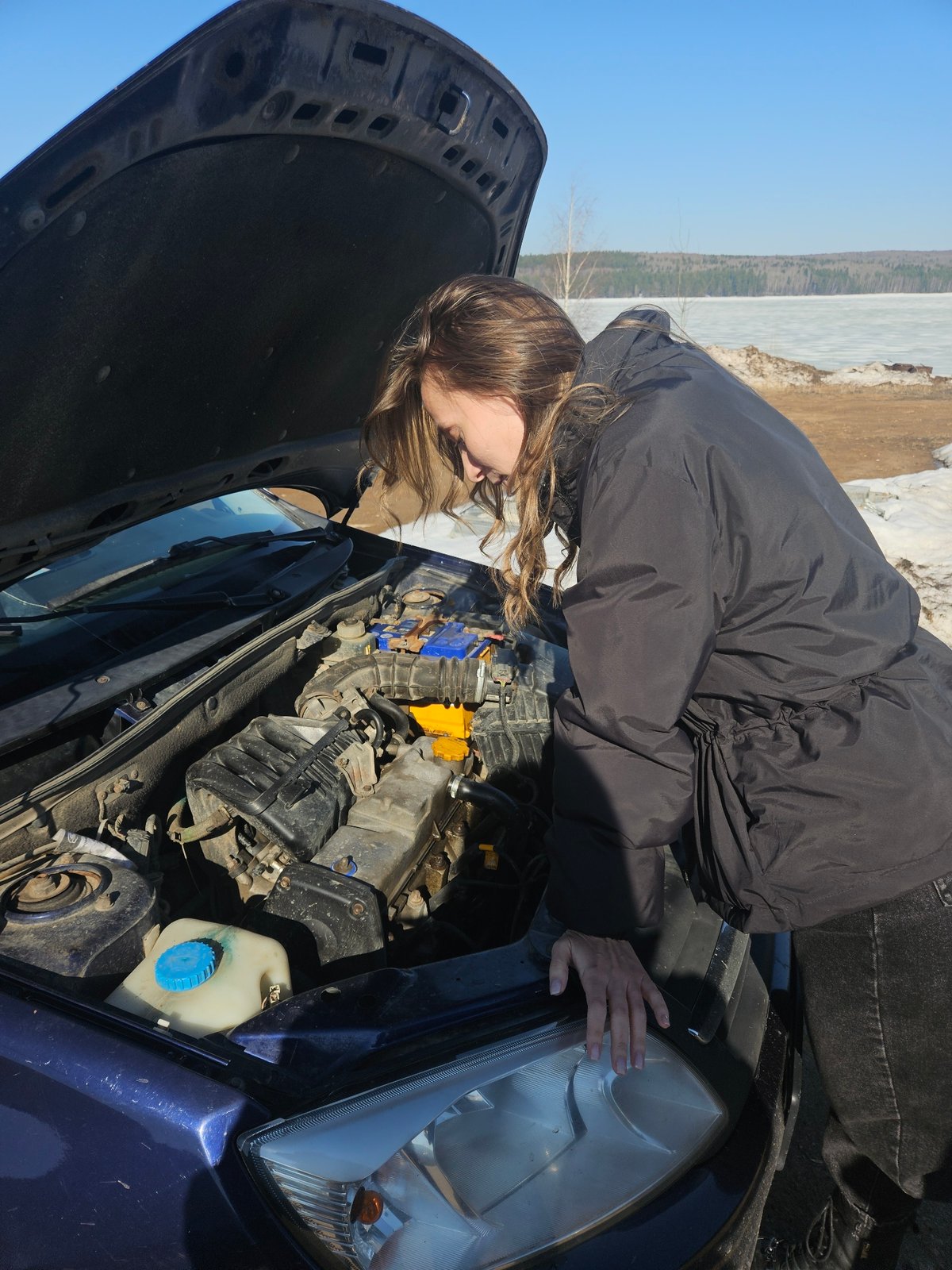 Woman documents daily routine with car repairs and selfies