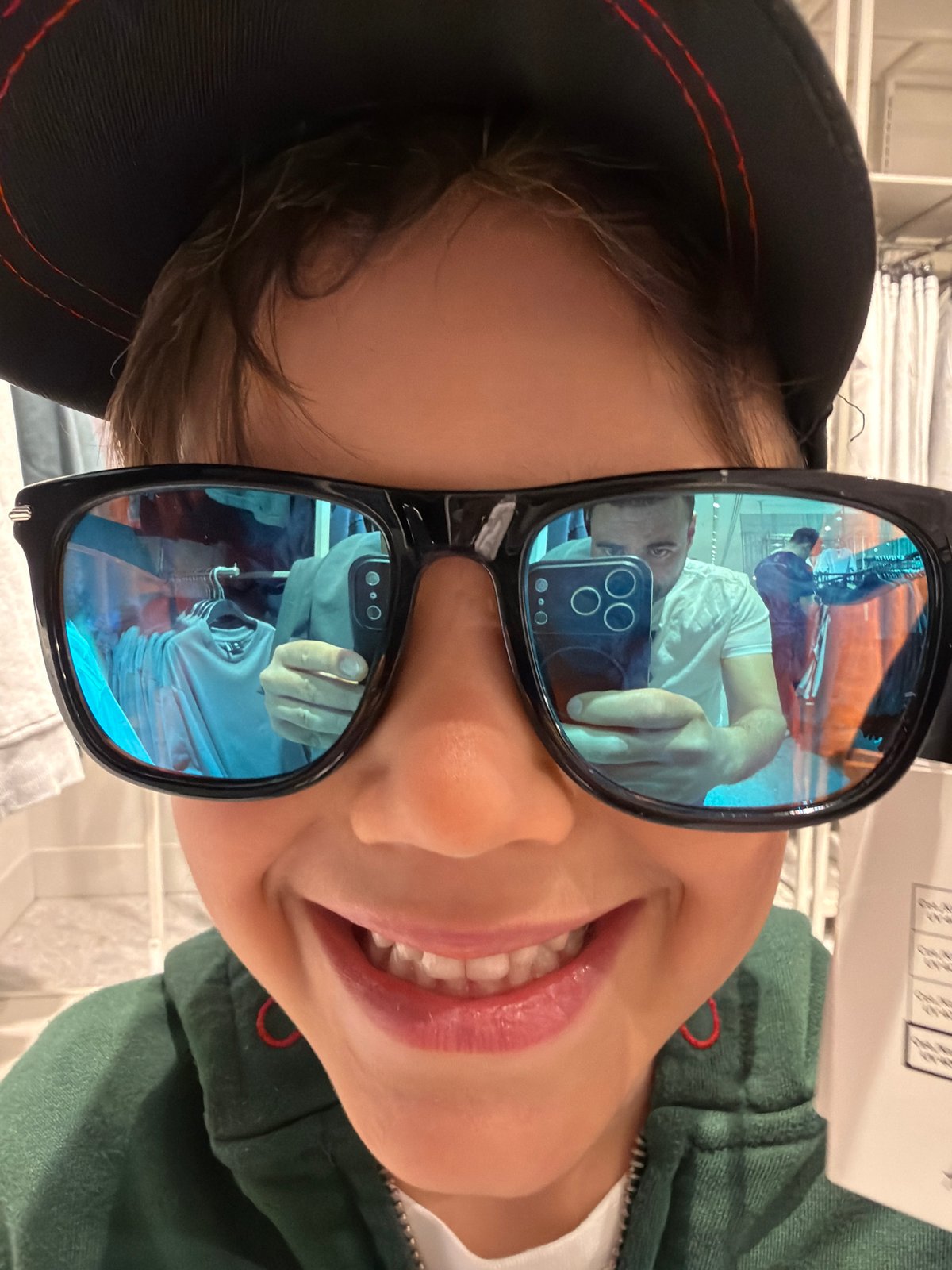 Family visits Hamleys toy store in London, views dinosaur display